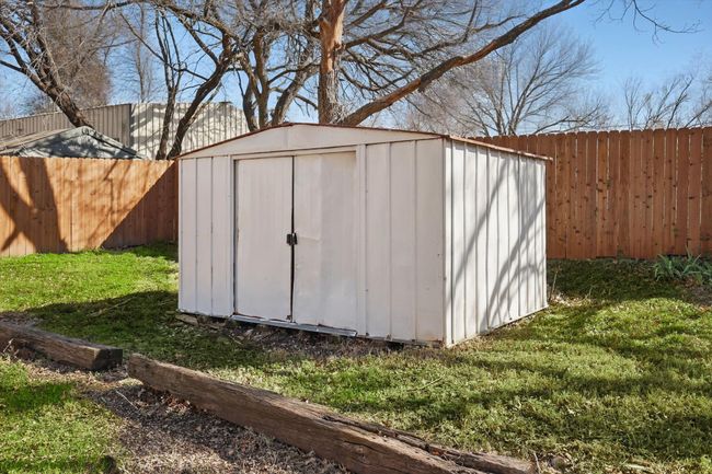View of shed with a fenced backyard | Image 32