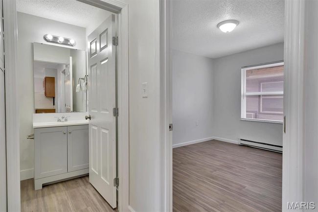 Hallway view of bathroom and bedroom | Image 13