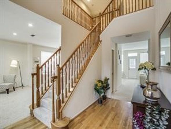 Stairs with wood finished floors, a towering ceiling, and recessed lighting | Image 10