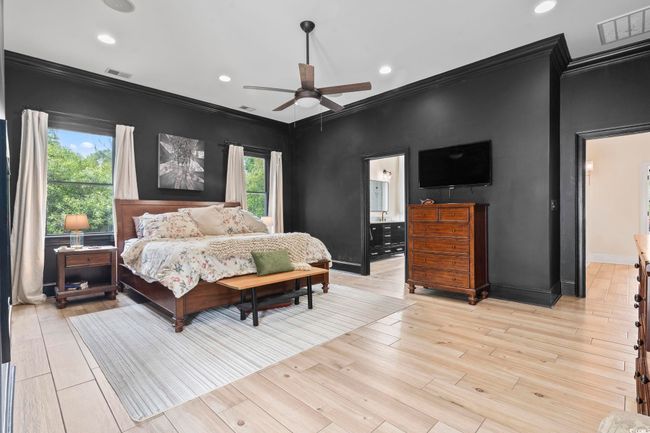 Bedroom featuring ornamental molding, baseboards, recessed lighting, light wood-style floors, and ensuite bath | Image 17