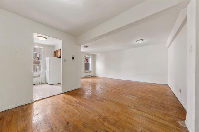 Unfurnished room with radiator heating unit and light wood-style floors | Image 4