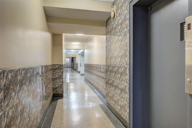Hall featuring tile walls and a wainscoted wall | Image 20