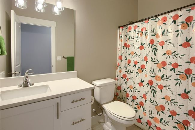 Bathroom featuring vanity, a shower with curtain, and toilet | Image 20
