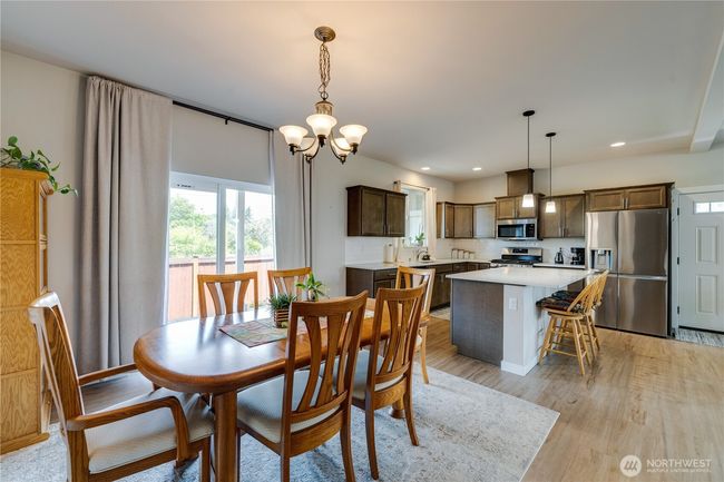 Dining room with kitchen ahead. Patio doors lead to back porch | Image 14