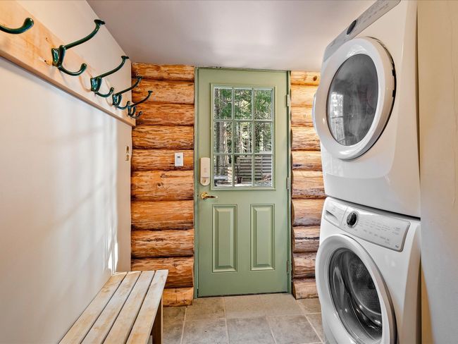 Laundry area with stacked washer and dryer and laundry area | Image 19