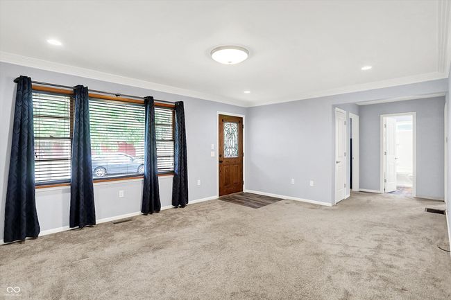 carpeted entrance foyer with crown molding, baseboards, and recessed lighting | Image 4