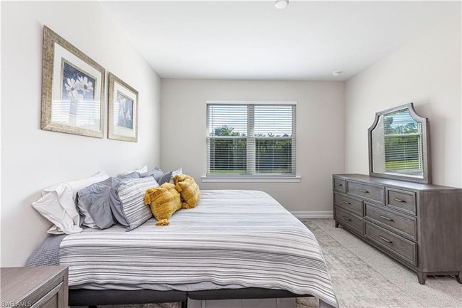 Bedroom featuring light carpet and baseboards | Image 11