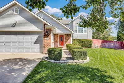 View of front of home featuring a front lawn and a garage | Image 1