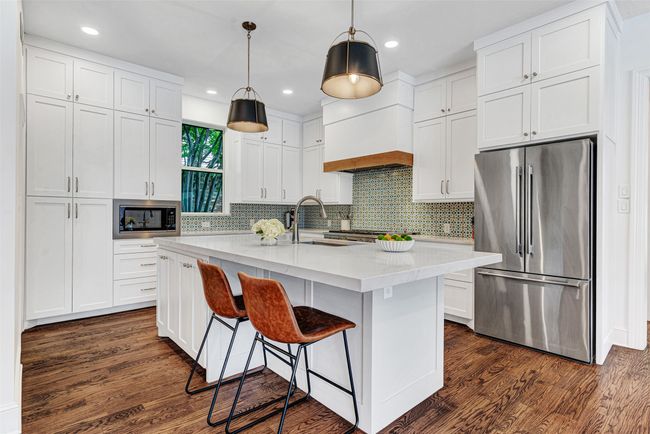 The gourmet kitchen was recently renovated to into a chef's dream! No matter your skill in the kitchen, you'll love preparing meals for family and friends here with the custom designed cabinets and 9' center island with quartz top. | Image 5