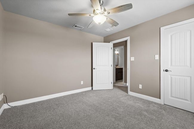 Unfurnished bedroom featuring carpet flooring, baseboards, and ceiling fan | Image 27