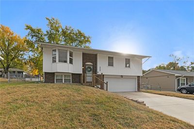 Raised ranch with a front lawn and a garage | Image 1