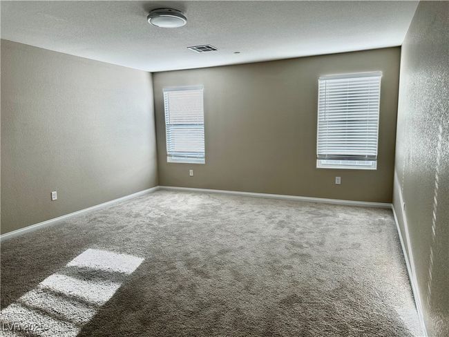 Empty room with carpet, visible vents, a textured ceiling, and a textured wall | Image 20