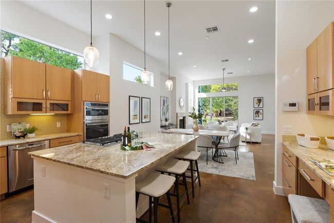Kitchen with stainless steel appliances, finished concrete floors, recessed lighting, plenty of natural light, and backsplash | Image 16