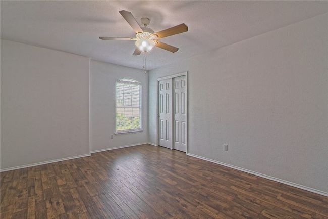 Spare room with dark wood finished floors and ceiling fan | Image 24