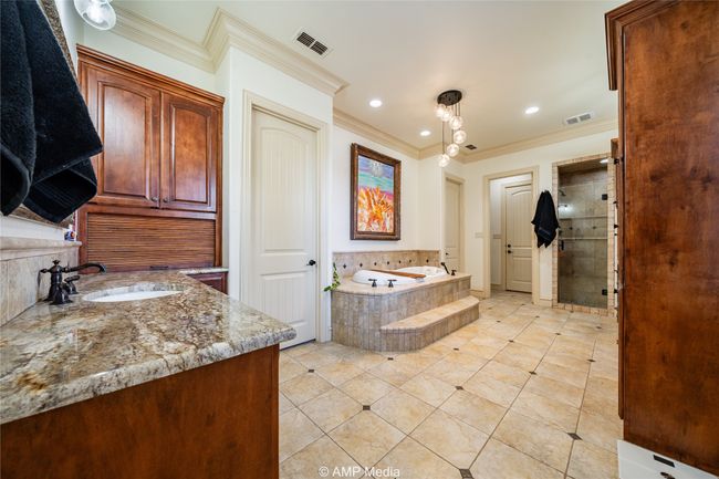 Bathroom featuring plus walk in shower, vanity, tile patterned floors, and crown molding | Image 22