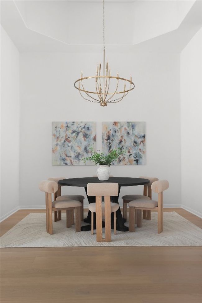 High ceiling and designer fixture create a dramatic dining space. | Image 15