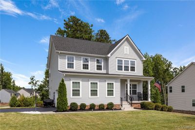 View of property featuring covered porch and a front lawn | Image 1