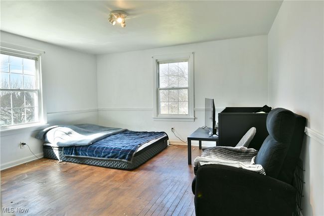 Bedroom with hardwood / wood-style floors and baseboards | Image 34