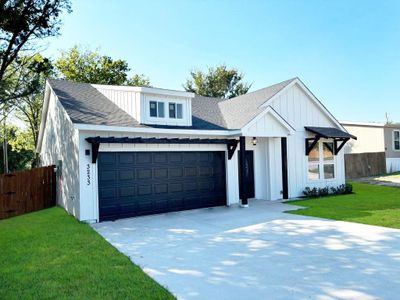 Modern inspired farmhouse with a garage and a front yard | Image 2