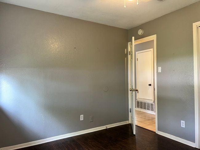 Unfurnished room featuring wood finished floors and baseboards | Image 16