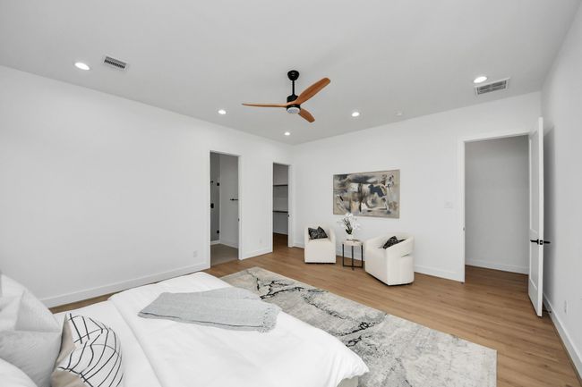 The primary bedroom has recessed lighting, ceiling fan, an en-suite bathroom, and walk-in closet. | Image 14