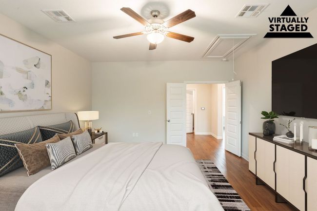 Bedroom featuring attic access, dark wood-style floors, and ceiling fan | Image 23