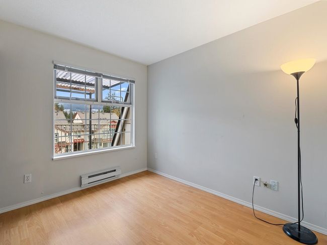 Spare room with baseboards, light wood-style flooring, and a baseboard heating unit | Image 14