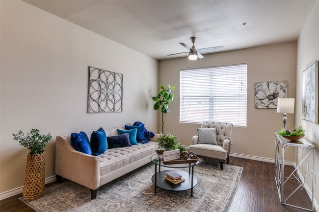 Living room with a ceiling fan and dark wood-type flooring | Image 6