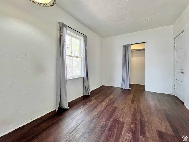 Unfurnished bedroom with wood finished floors and a closet | Image 20