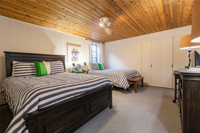 Carpeted bedroom featuring wooden ceiling | Image 13