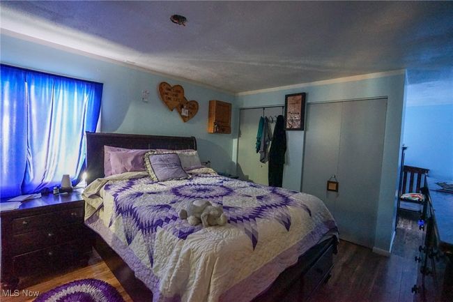 Bedroom with wood finished floors and a closet | Image 15