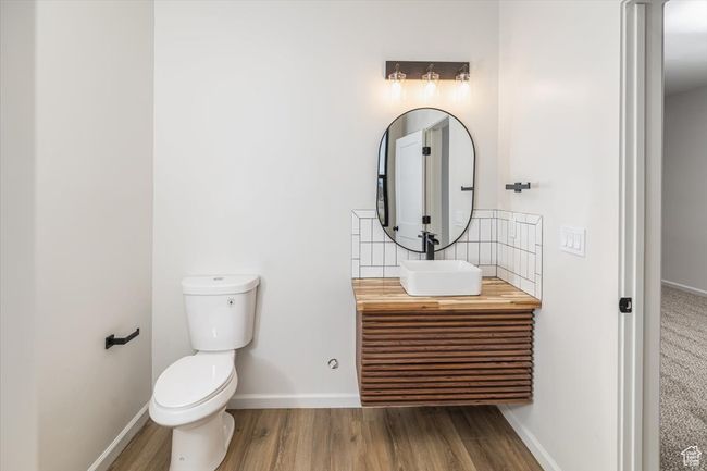 Bathroom featuring vanity, wood-type flooring, and toilet | Image 40