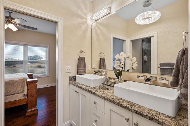 Jack-and-Jill bathroom include dual sinks, tub/shower combo and a skylight, creating a bright and functional space. | Image 23