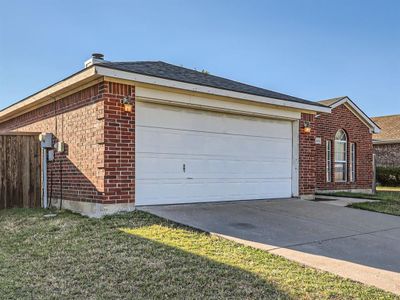 View of front of house featuring a front yard and a garage | Image 3