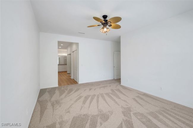 Unfurnished room with visible vents, a ceiling fan, and light carpet | Image 10