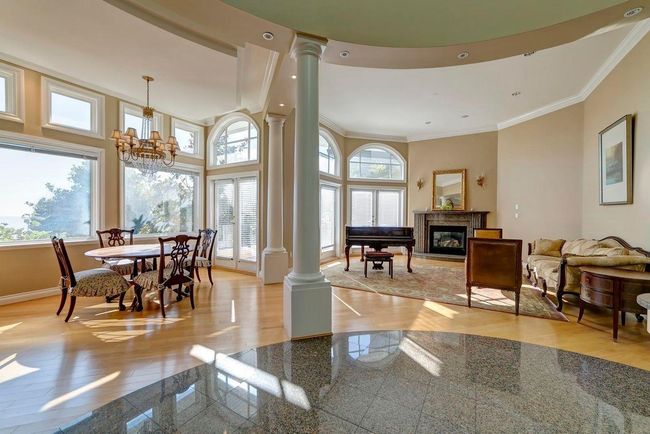 Dining area featuring crown molding, granite finish floor, baseboards, and ornate columns | Image 16