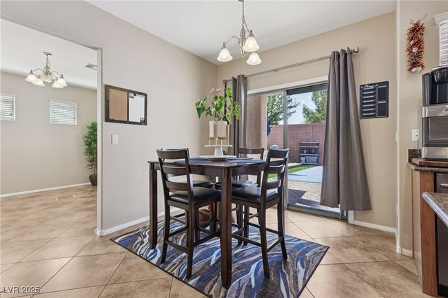 Dining area featuring a chandelier, healthy amount of natural light, and light tile patterned floors | Image 22