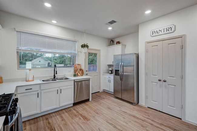 This beautiful kitchen is the heart of the home—featuring a large window that floods the space with natural light and offers a peaceful view of the outdoors. Whether you're preparing meals, sipping morning coffee, or enjoying casual conversation, the open, airy atmosphere makes every moment feel fresh and inviting. | Image 13