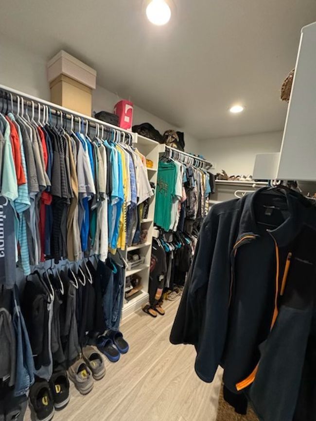 Spacious closet with light wood-style floors | Image 7