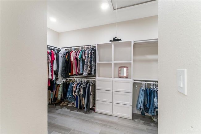 Spacious closet with light hardwood / wood-style flooring | Image 11