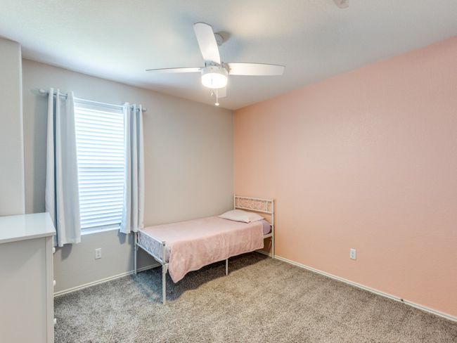 Carpeted bedroom with multiple windows and a ceiling fan | Image 27