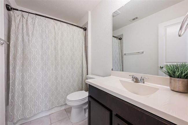 Bathroom with vanity, tile patterned flooring, and toilet | Image 22