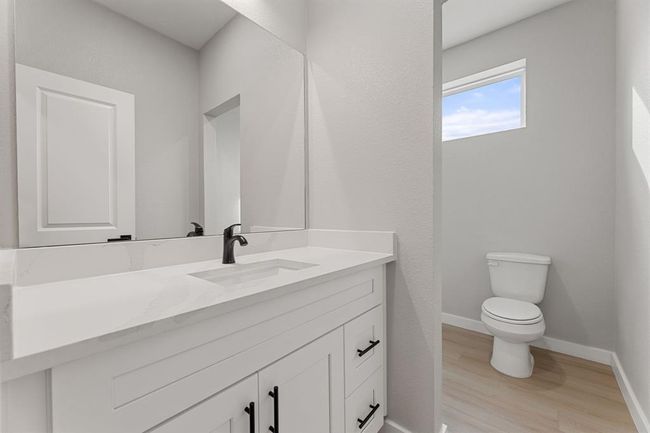 Upstairs full bathroom. The spacious bathroom offers quartz countertops, a large sink, and a shower/tub combo for ultimate convenience. | Image 16