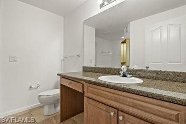 Bathroom featuring toilet, tile patterned floors, vanity, and baseboards | Image 21