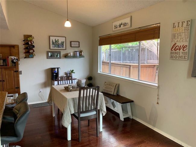 Dining space with baseboards, vaulted ceiling, and wood finished floors | Image 5