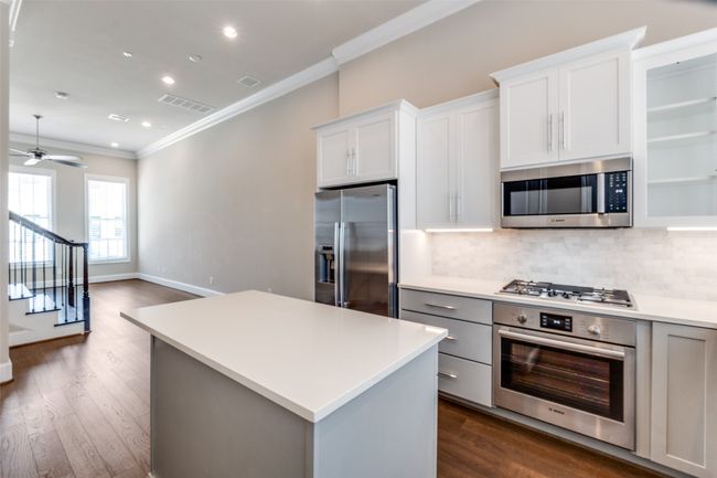 Kitchen featuring stainless steel appliances, ornamental molding, tasteful backsplash, dark wood finished floors, and recessed lighting | Image 14