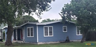 View of East side of unit, fully fenced rear yard w/gate, mature trees. | Image 2