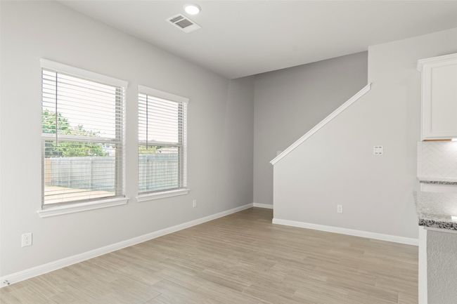 Spare room with light wood finished floors, baseboards, and stairs | Image 10