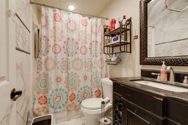Bathroom featuring vanity and a shower with shower curtain | Image 31