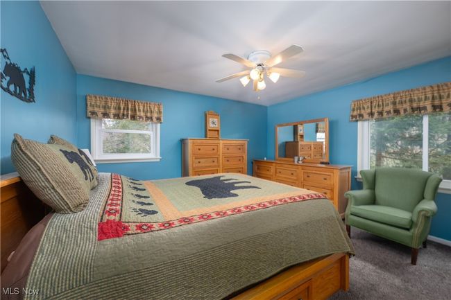 Bedroom with carpet floors, baseboards, and ceiling fan | Image 27